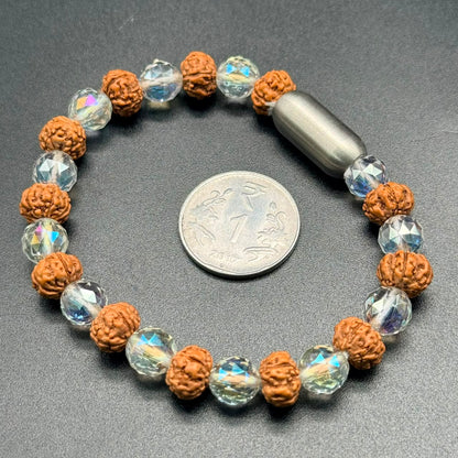 Aura clear quartz and 5 Mukhi Rudraksha magnetic bracelet with bead and crystal segments, shown flat with coin