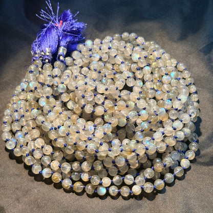 Close-up of labradorite 6mm mala beads with blue knots and tassel
