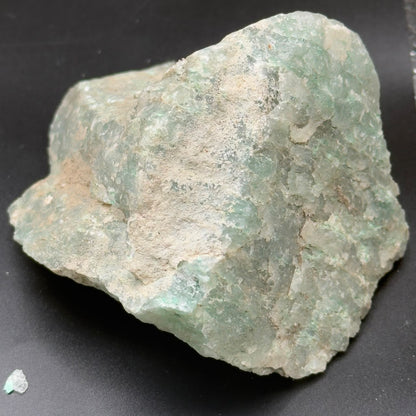 Close-up of rough Amazonite stone showing pale aqua green veining on white matrix