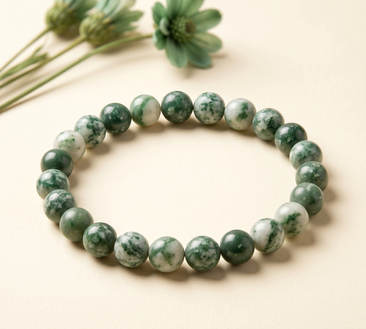 Close-up of green spot jasper bracelet beads with white marbling and dark green spots