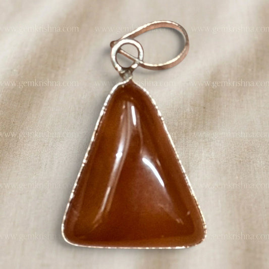 Close-up of red onyx locket pendant showing glossy stone and silver-tone wire setting