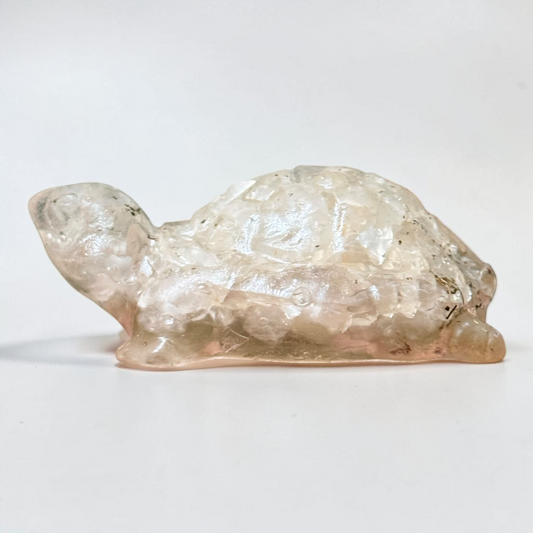 Crystal quartz turtle carving with smooth legs and shell texture on white background