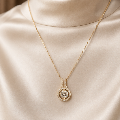 CZ solitaire 925 sterling silver halo pendant worn on a gold-tone chain against satin fabric