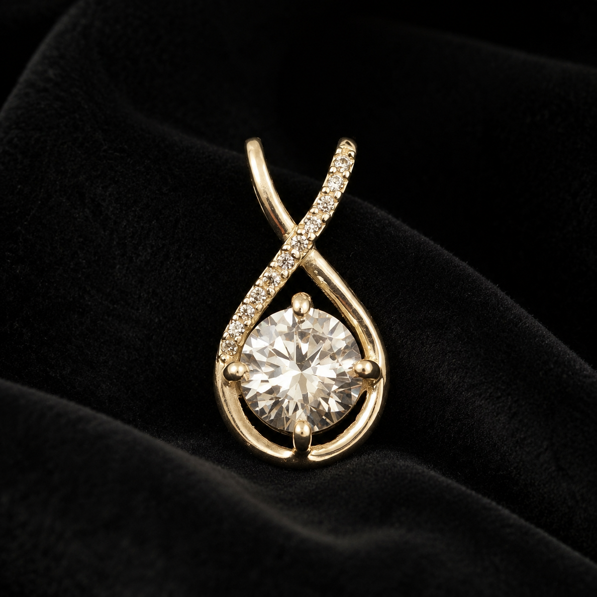 Close-up of CZ solitaire sterling silver teardrop pendant on dark velvet background