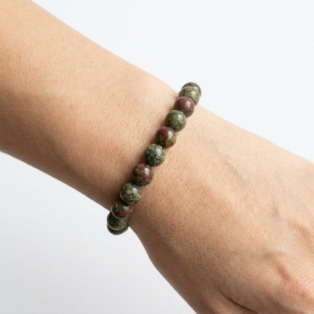 Natural dragon blood jasper beaded bracelet worn on wrist with green and red stones