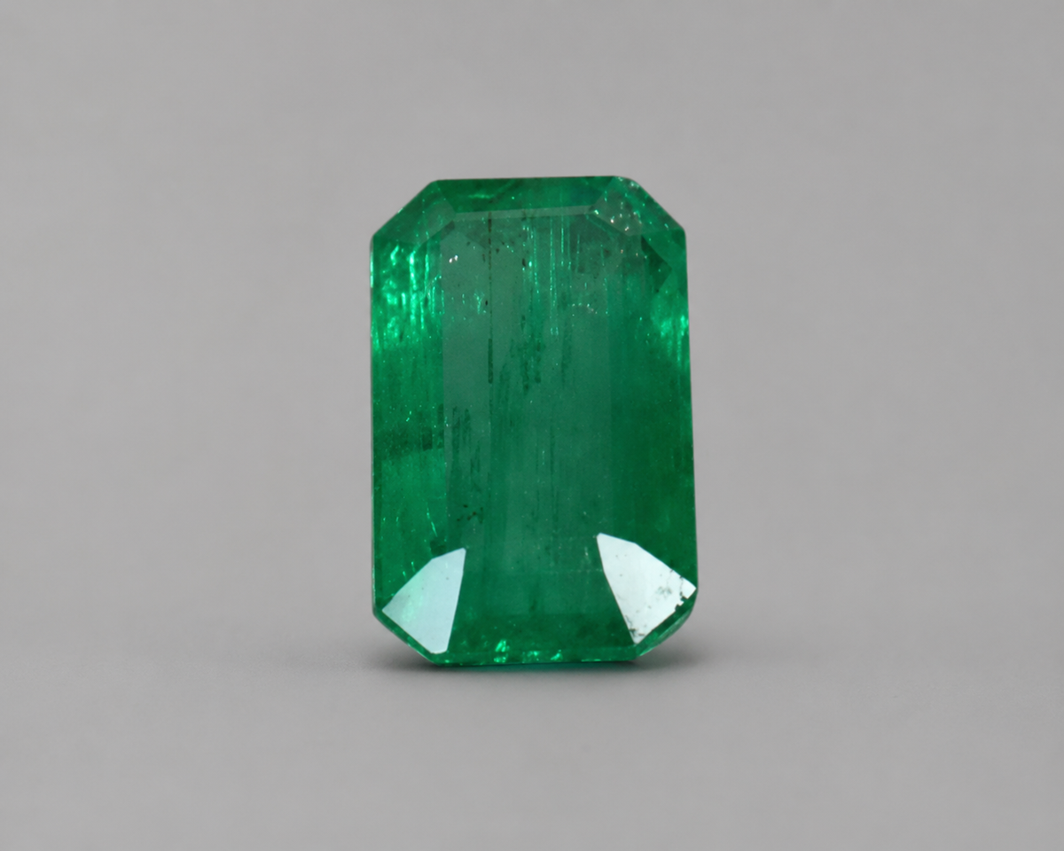 Emerald cut green emerald gemstone with step facets in front view