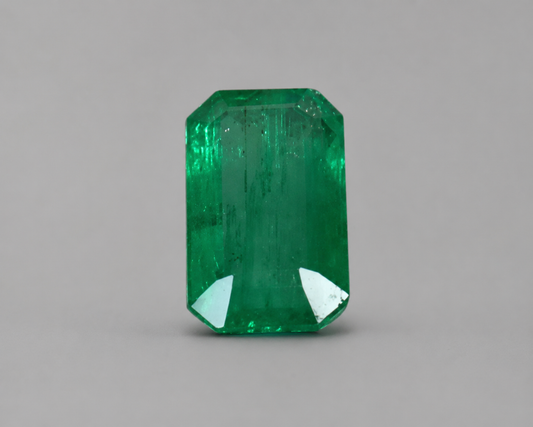 Emerald cut green emerald gemstone with step facets in front view