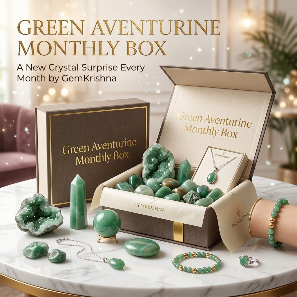 Green Aventurine Monthly Box with gemstones and jewelry on a marble display table