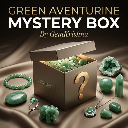 Green aventurine crystal mystery box with gemstones, bracelet, ring and pendant on satin