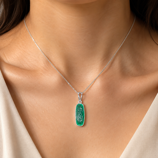 Green onyx carved pendant on a silver chain worn on model neckline