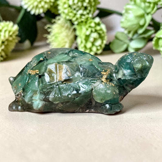 Green jade turtle figurine with gold-tone inclusions, close-up on shell and head