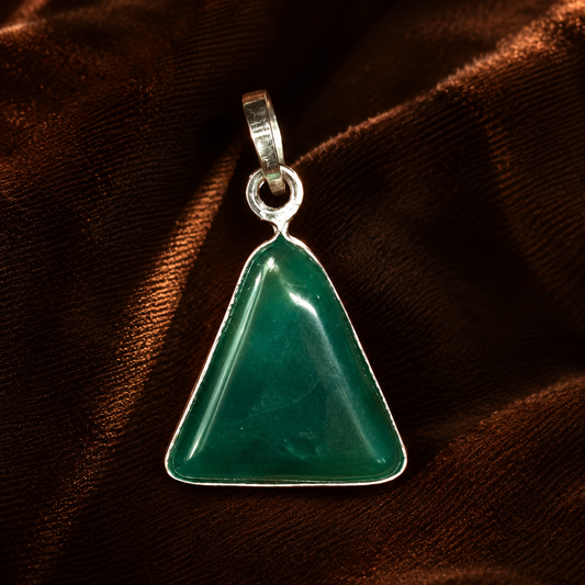 Green onyx triangle locket pendant with polished silver-toned bail on dark textured background