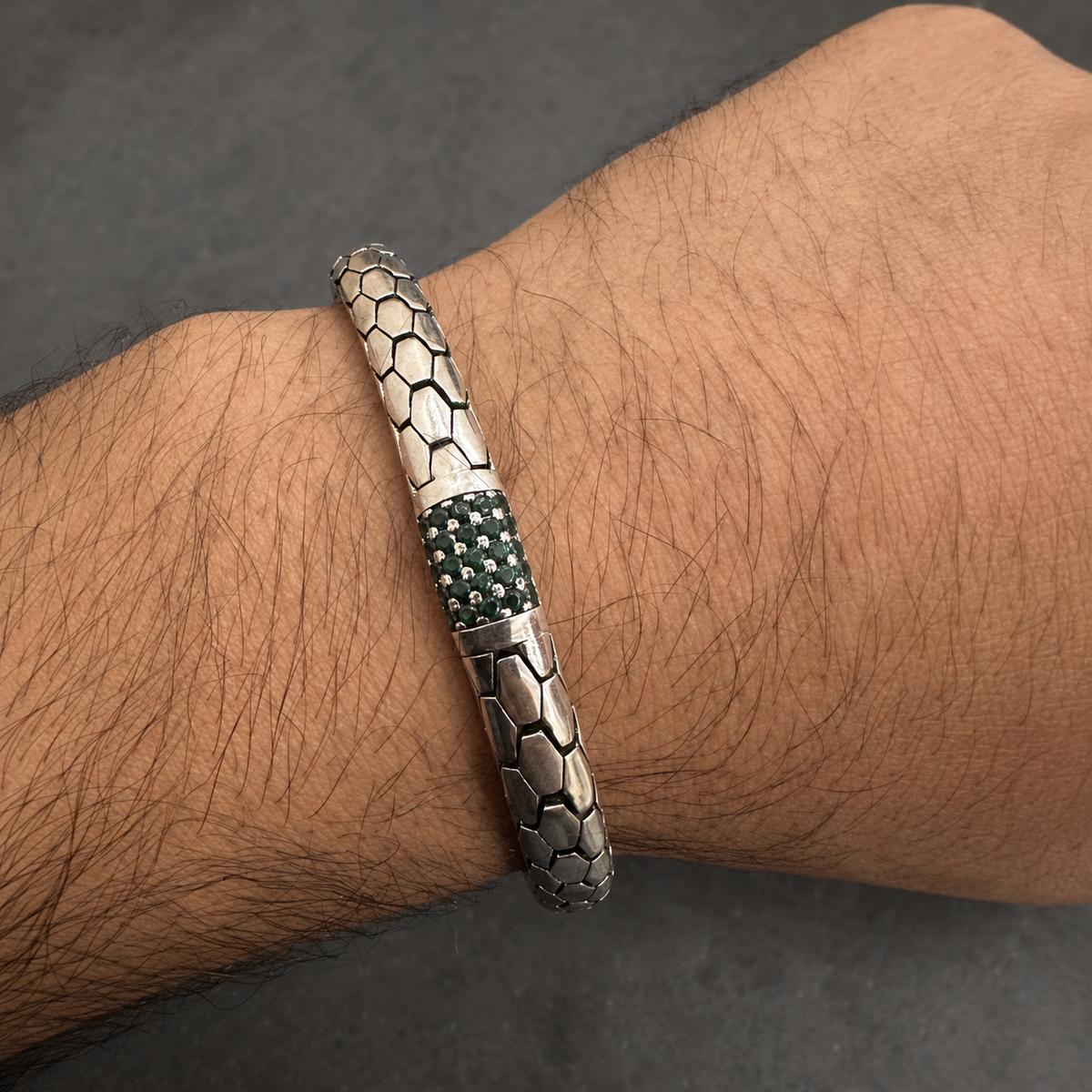 Green stone snake scale 925 sterling silver bracelet worn on a man’s wrist, side view