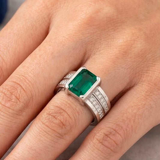 Silver emerald green panna ring on hand with pavé accents on the band