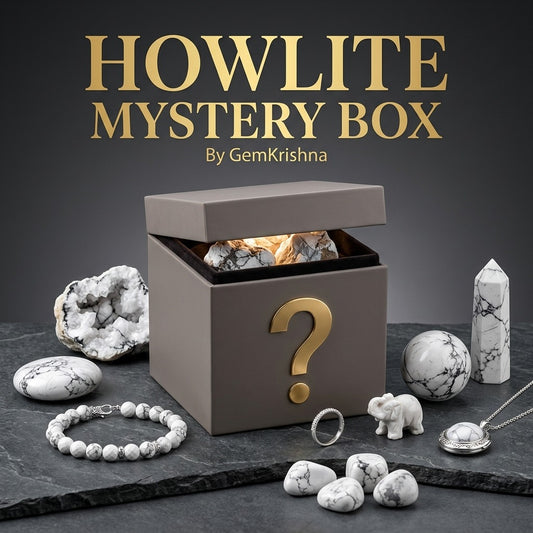 Howlite crystal mystery box with gemstone accessories on black stone surface