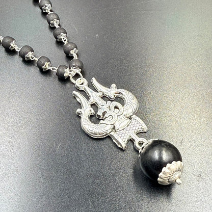 Karungali bead mala with Om Trishul metal pendant and silver clasp on grey background