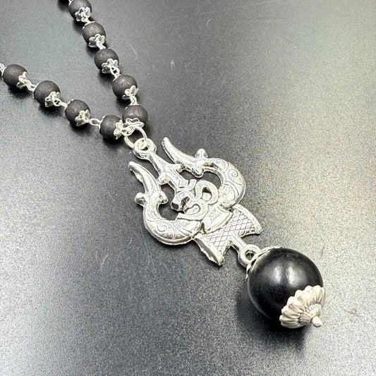 Karungali bead mala with Om Trishul metal pendant and silver clasp on grey background
