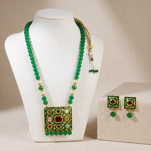 Kundan mala necklace with semi-precious bead strand and matching square earrings on jewelry display
