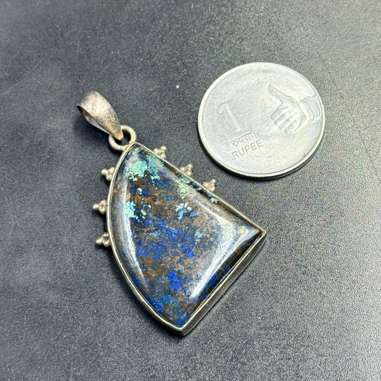 Lapis azurite 925 silver locket pendant with blue stone center on dark background