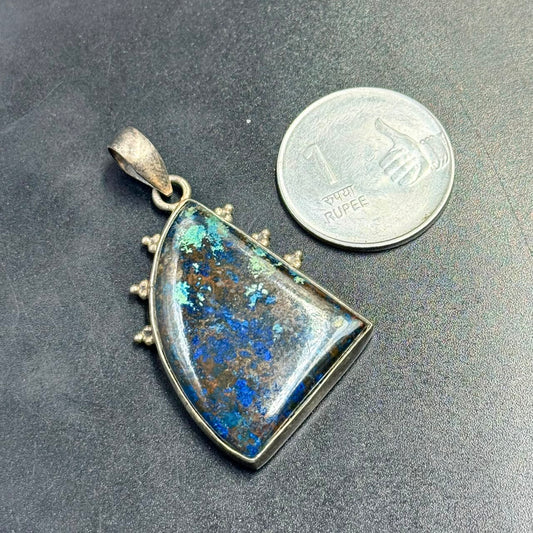 Lapis azurite 925 silver locket pendant with blue stone center on dark background