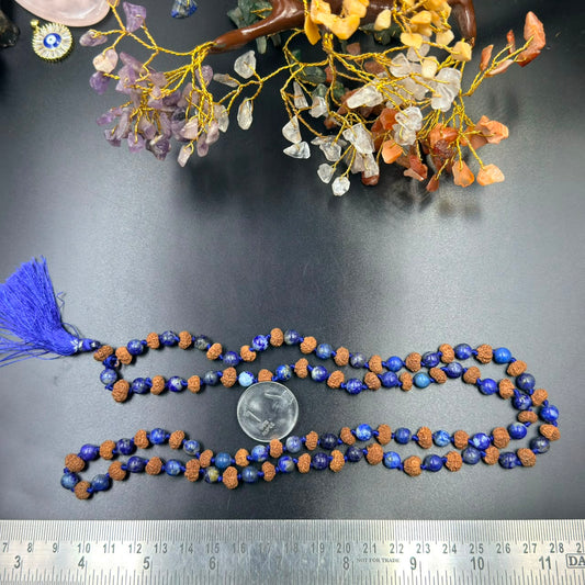 Jaap mala string of blue lapis lazuli and rudraksha beads with tassel shown on ruler