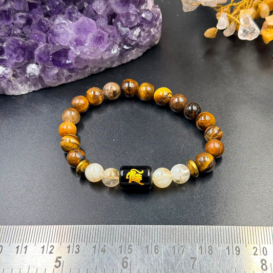 Leo (Singh) zodiac bracelet laid flat with tiger eye and citrine beads and black Leo charm center