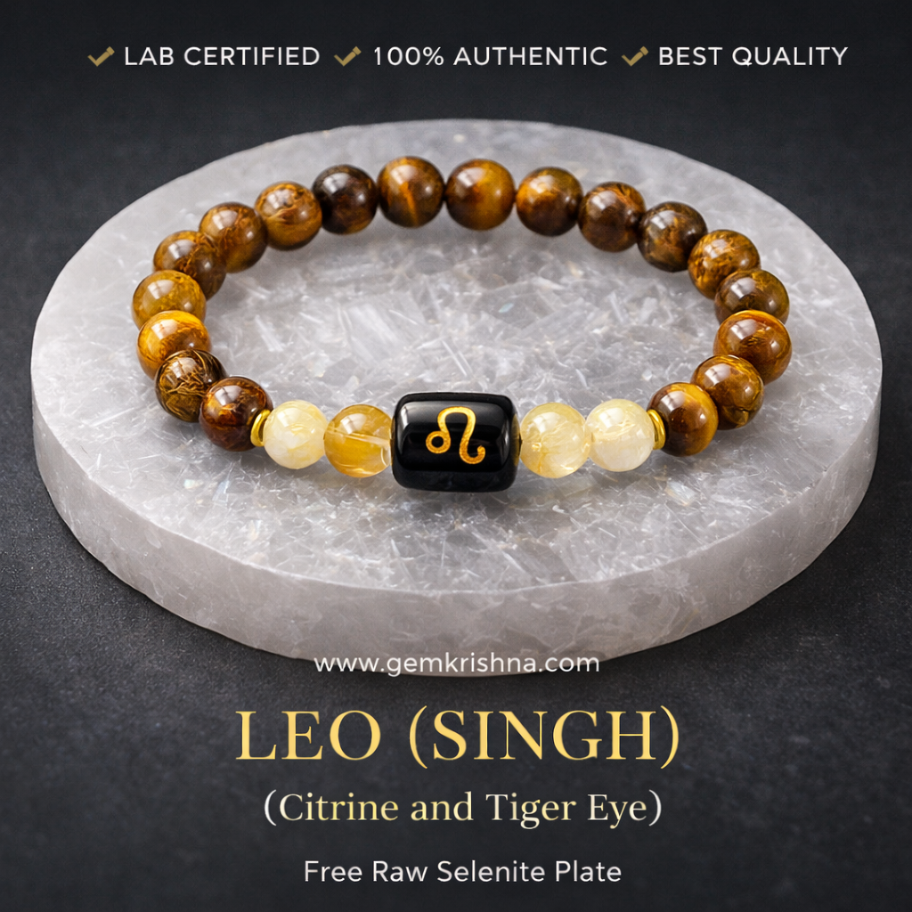 Leo (Singh) zodiac bracelet with tiger eye and citrine beads plus raw selenite plate on black surface