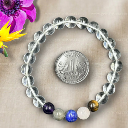 Close-up of Libra Bracelet clear crystal quartz beads with purple and blue accent stones and charm coin