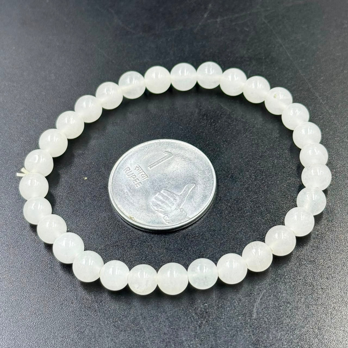 Milky Quartz 6mm bracelet showing round white beads and close clasp end