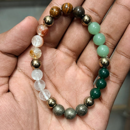 Money magnet bracelet held in hands showing citrine and green aventurine style beads with gold accents