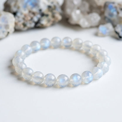 Moonstone bead bracelet with round moonstone spheres, soft blue shimmer on white background
