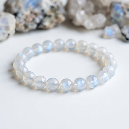 Moonstone bead bracelet with round moonstone spheres, soft blue shimmer on white background