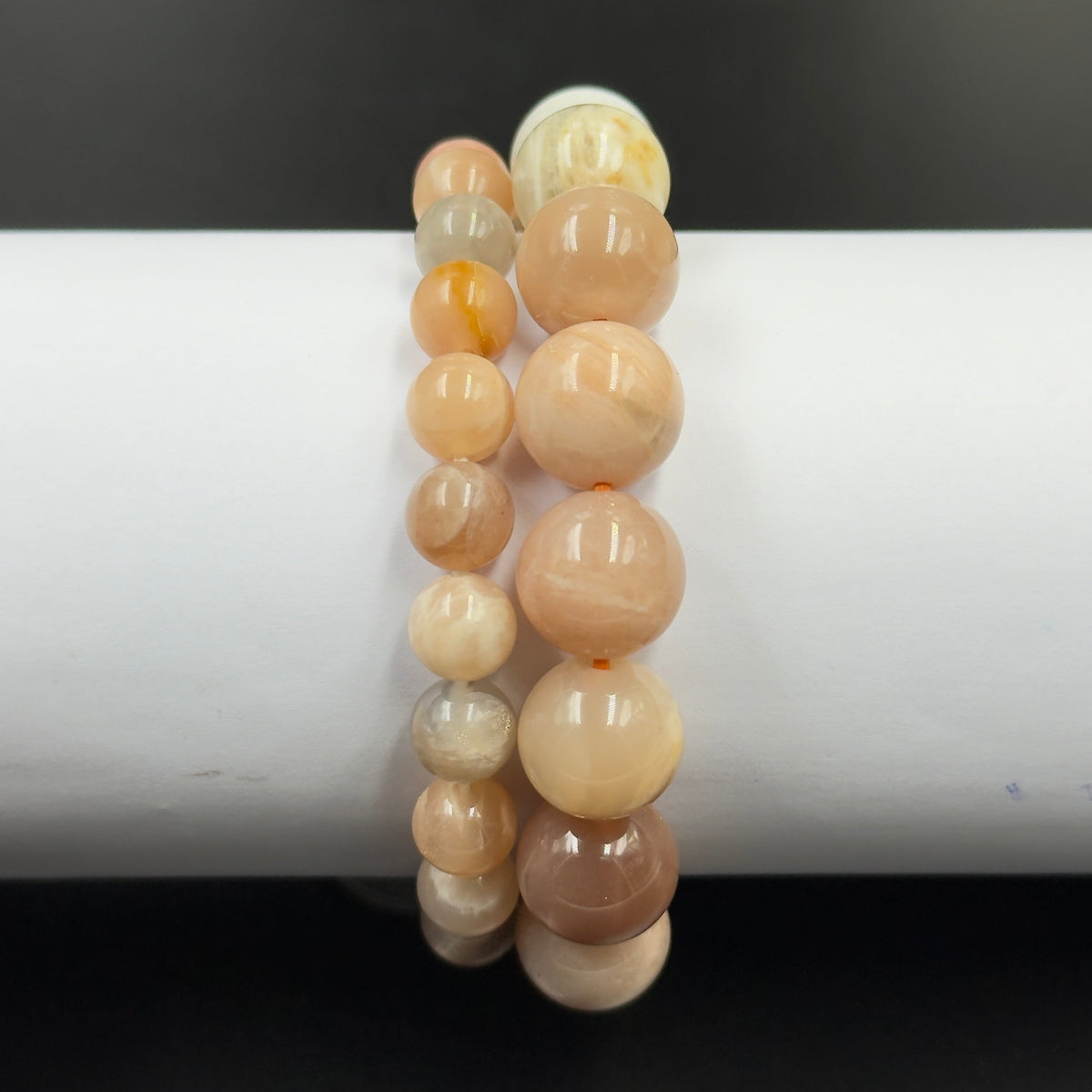 Multi moonstone bracelet close-up of round beads in warm cream and orange tones