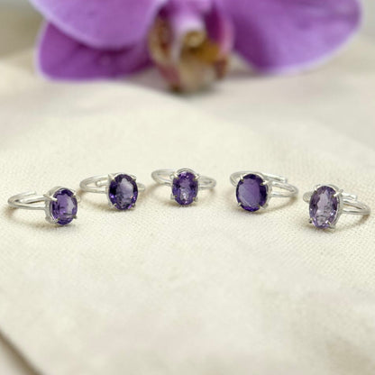 Natural amethyst adjustable ring featuring a purple oval stone in a silver-toned setting
