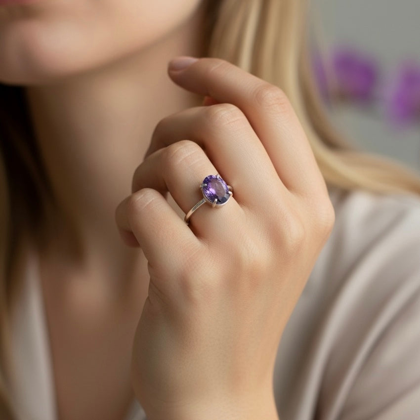 Natural amethyst adjustable ring worn on hand showing purple oval gemstone and open band