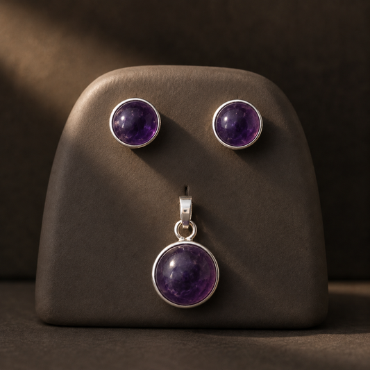 German silver natural amethyst cabochon earrings and pendant set on jewelry stand