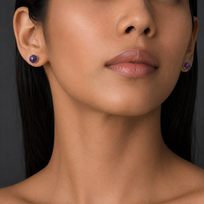 Natural amethyst cabochon stud earrings in German silver on model close-up