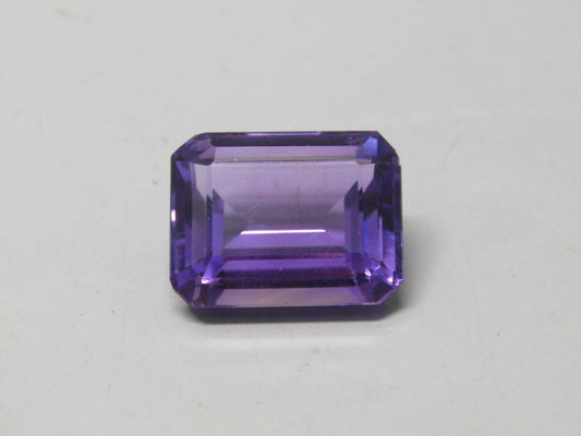 Natural amethyst quartz emerald-cut gemstone, deep purple rectangular stone