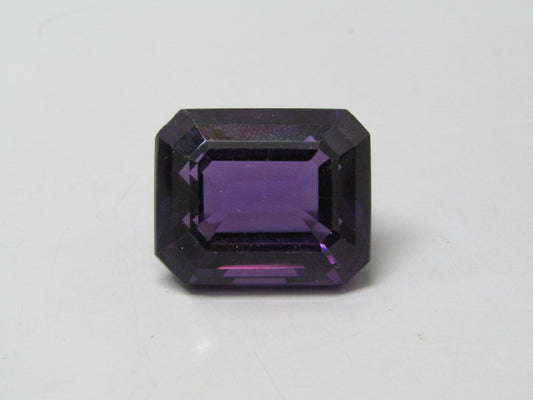 Natural amethyst quartz gemstone with emerald cut faceting, deep purple color