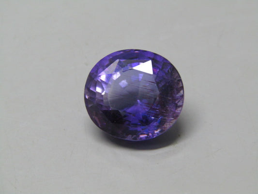 Natural amethyst quartz oval gemstone with deep violet color and faceted sparkle