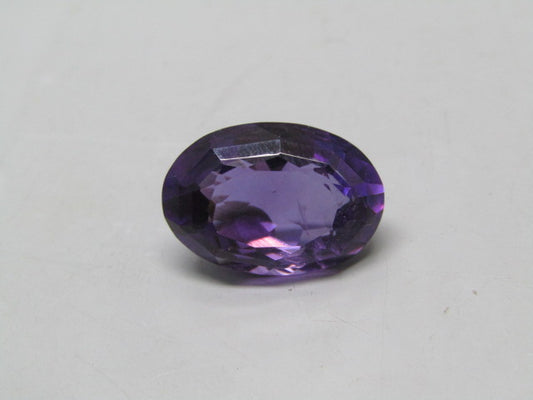 Natural amethyst quartz oval gemstone cabochon with faceted purple luster