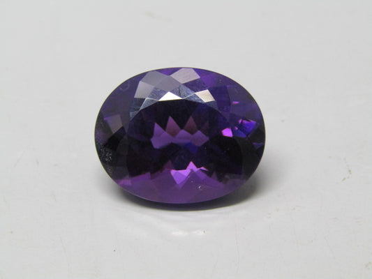 Natural amethyst quartz oval gemstone with deep purple faceted luster