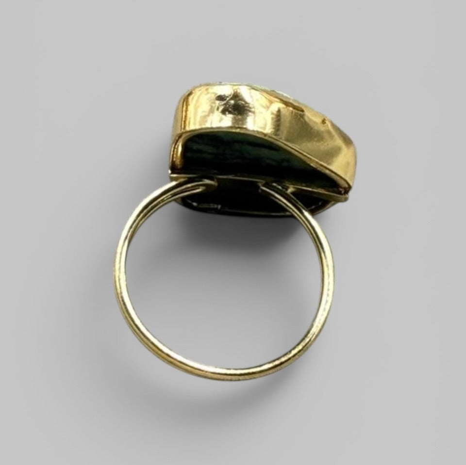 Back view of natural amethyst rough metal ring showing gold-toned band and setting base