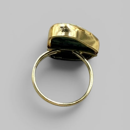 Back view of natural amethyst rough metal ring showing gold-toned band and setting base