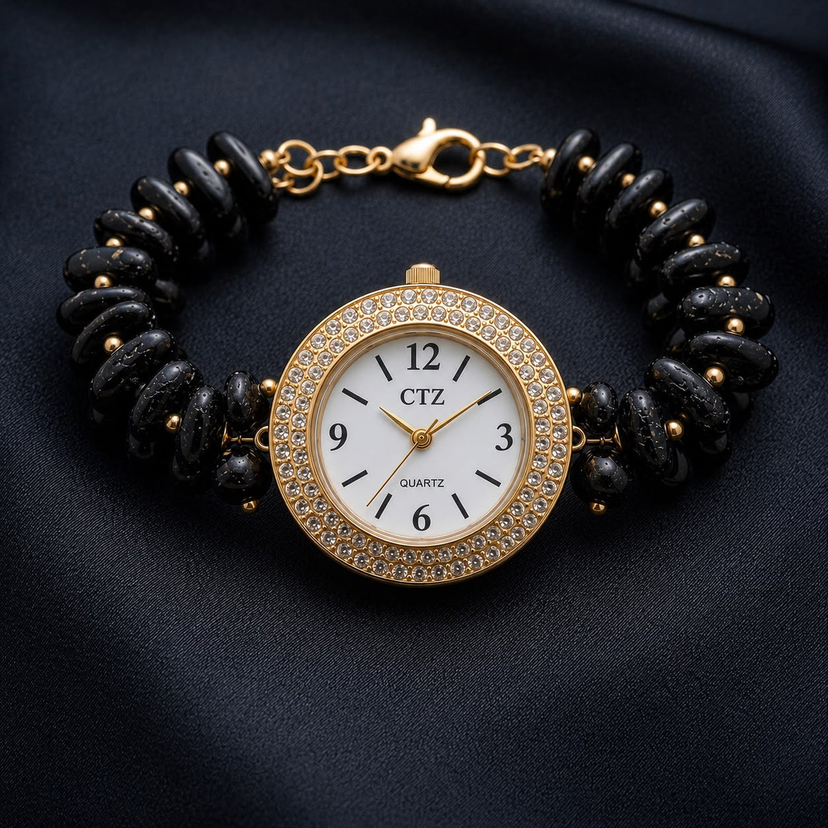 Natural black tourmaline wrist watch with gold-tone dial and crystal-studded bezel on beaded bracelet