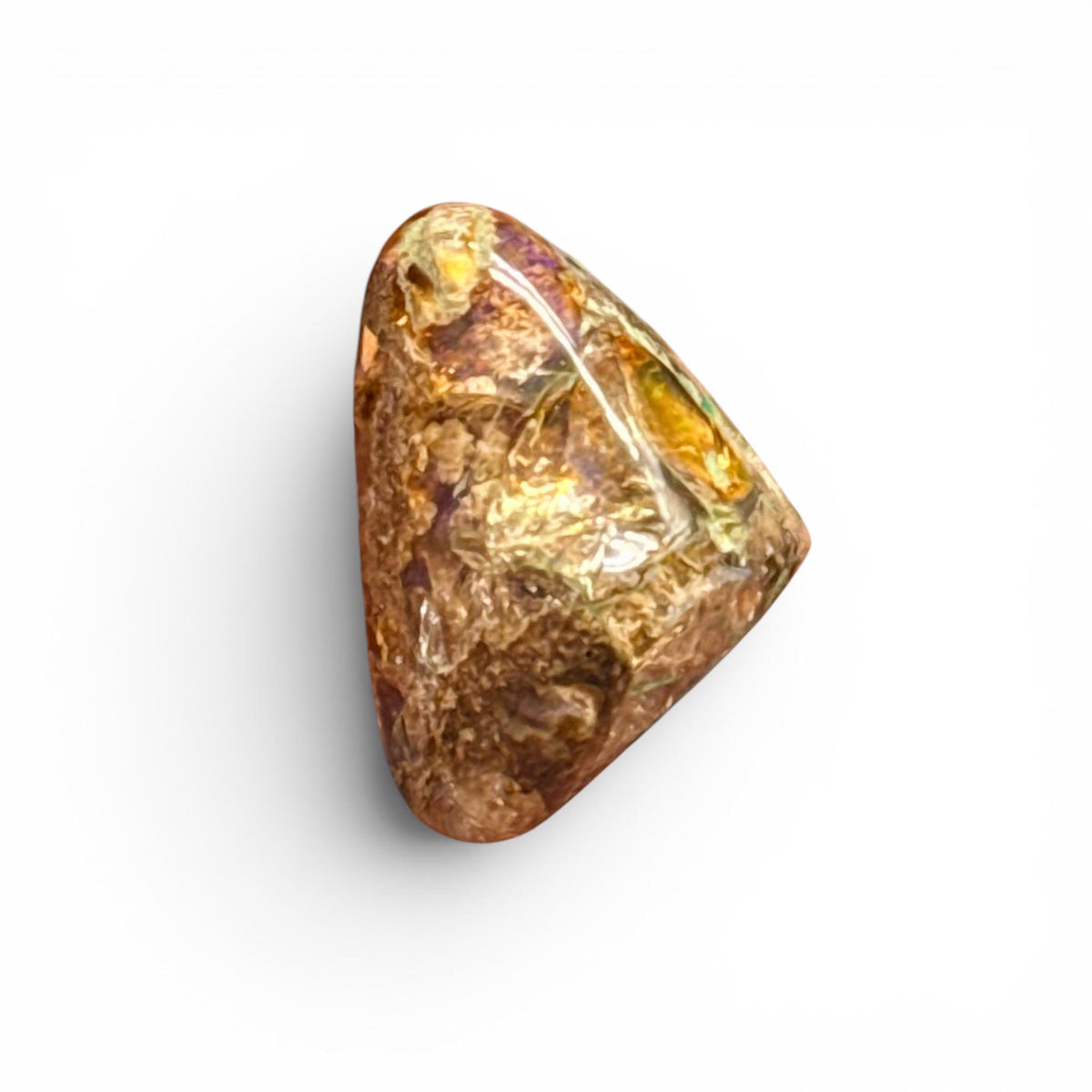 Natural boulder fire opal loose gemstone close-up with golden and purple tones
