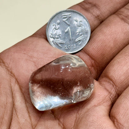 Natural clear quartz tumble gemstone close up for spiritual healing and negativity protection