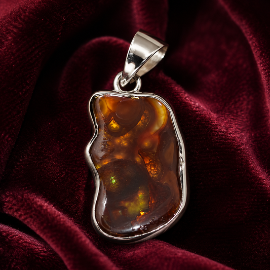 Natural fire agate 925 silver freeform pendant on deep red velvet background