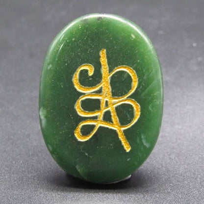 Natural green jade coin pendant with gold harmony symbol front view on gray background