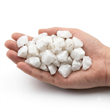 A hand holding a heap of natural raw milky quartz chips on a white background